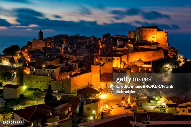 twilight over medieval village giglio castello, giglio island, tuscany, italy - giglio stock-fotos und bilder