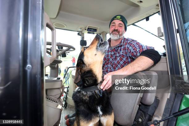 Rex Mills and his dog Bear join farmers and tradies in a protest convoy through Warkworth on July 16, 2021 in Auckland, New Zealand. Farmers and...