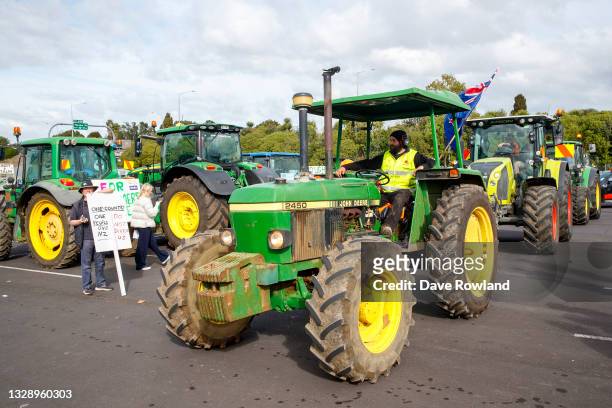 Farmers with their tractors regroup to return home after a protest drive on July 16, 2021 in Auckland, New Zealand. Farmers and rural residents are...