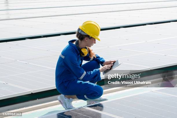 engineer women working on solar rooftop. - roof replacement stock pictures, royalty-free photos & images