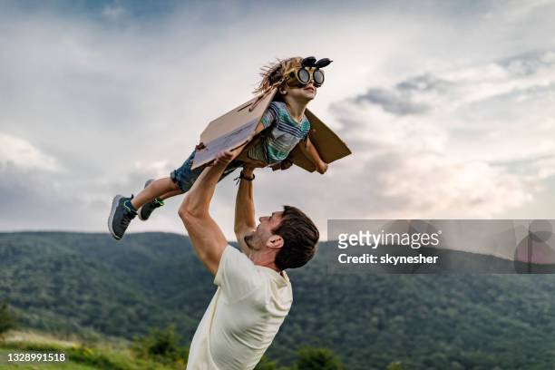wee daddy, i'm flying like an airplane! - boy flying stock pictures, royalty-free photos & images