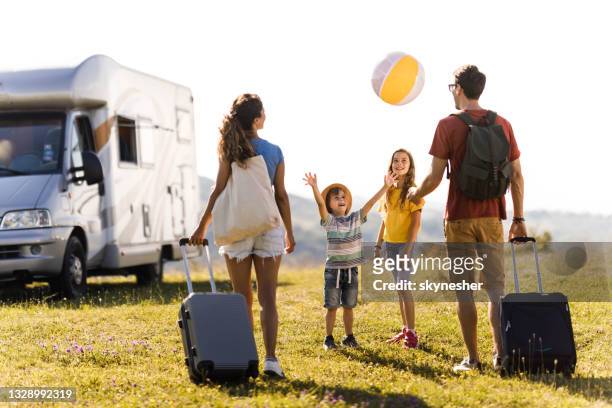 young happy family going on a vacation with their camper trailer. - caravan holiday family imagens e fotografias de stock