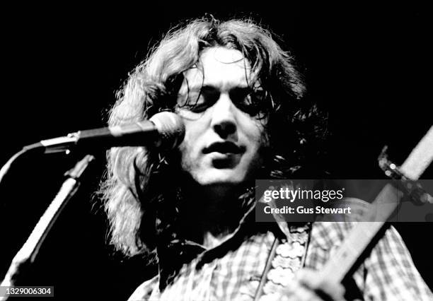 Rory Gallagher performs on stage at the Royal Albert Hall, London, England, on December 23rd, 1975.