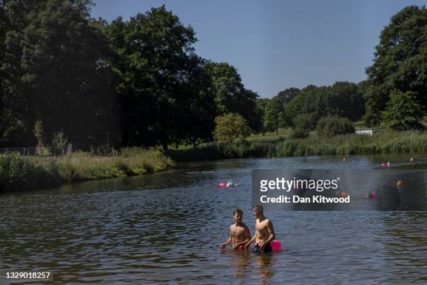 People swim in the lake at Beckenham Place Park on July 16, 2021 in Beckenham, England.