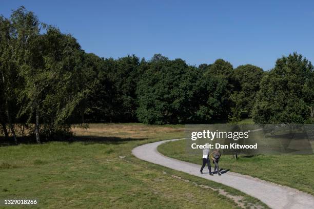 People walk through Beckenham Place Park on July 16, 2021 in Beckenham, England.