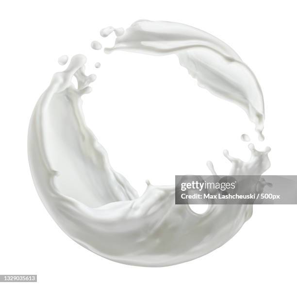 circle milk splash isolated on white background - milk stream stock pictures, royalty-free photos & images