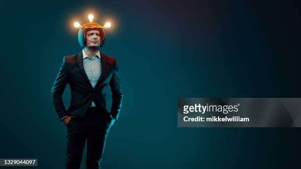 portrait of man who gets a great idea while wearing a helmet - mind reading stock pictures, royalty-free photos & images