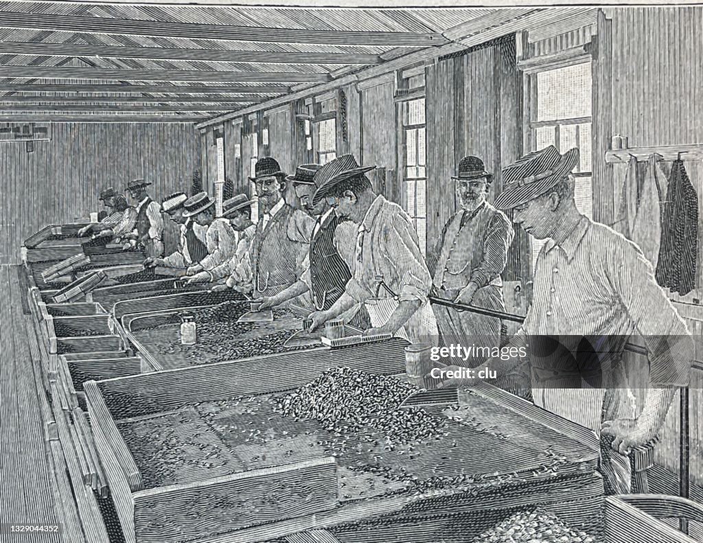 Diamond pits in South Africa, Kimberley, men in a row filtering out diamonds, supervisor in background