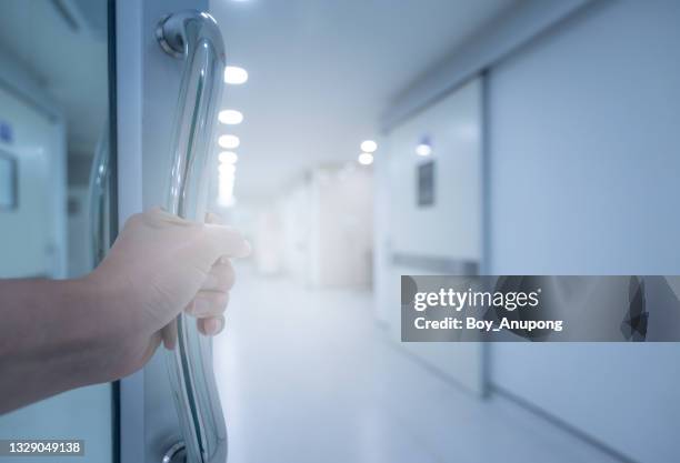 someone hand pushing door for entering to o.r (operating room) area in hospital. - hospital doorway stock pictures, royalty-free photos & images