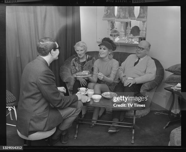 Journalist Dave Lanning interviewing English pop singer Dusty Springfield with her parents Gerald and Catherine O'Brien, with tea and cake at their...