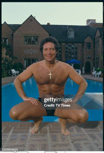 Welsh singer Tom Jones posed in trunks by a swimming pool at his home in Los Angeles, circa 1987.