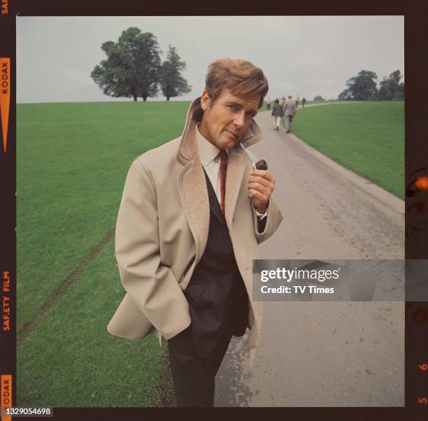 Actor Roger Moore, known for his role as Simon Templar in spy thriller series The Saint, smoking a pipe outdoors, circa 1968.