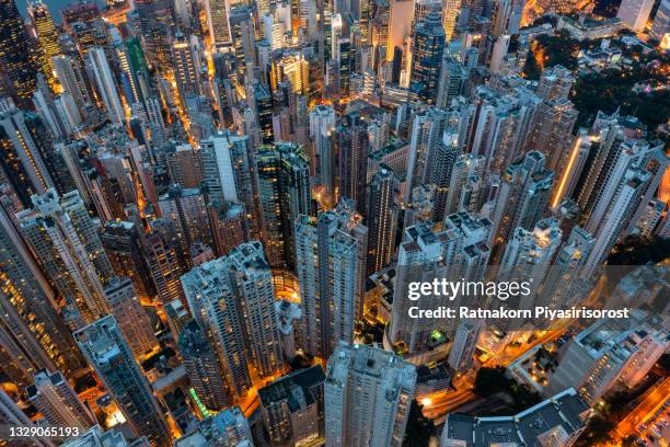 aerial view of hong kong downtown. financial district and business centers in smart city in asia. top view of skyscraper and high-rise buildings - oberteil stock-fotos und bilder