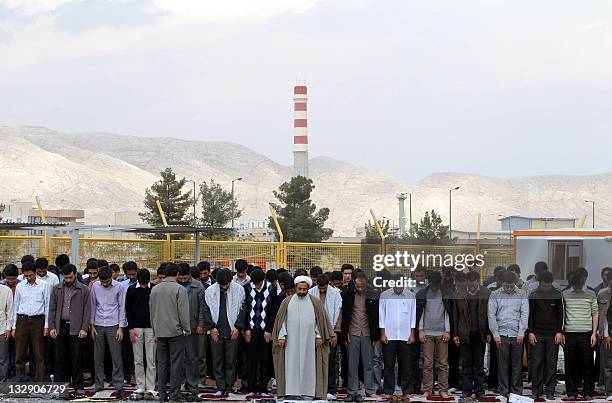 Iranian students pray outside the Isfahan Uranium Conversion Facility during a protest in the city in support of Iran's nuclear program and against...