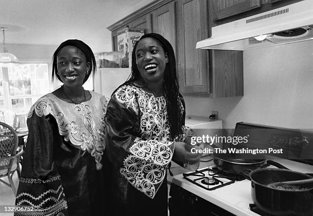 Hafsat Abiola cooks dinner with her sister Khafila at their townhouse on June 7, 1998 in Mitchelville, Maryland.