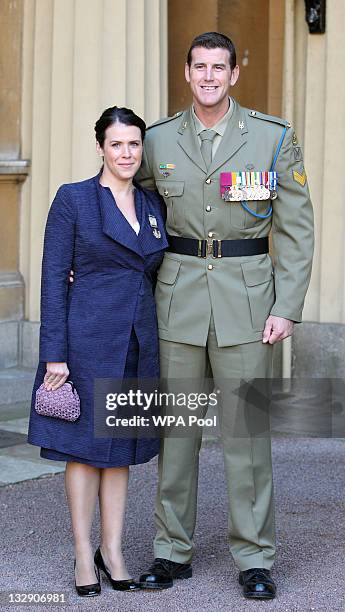 Corporal Benjamin Roberts-Smith with his wife Emma pose at Buckingham Palace following his audience with the Queen after being presented with the...