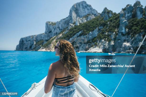 woman relaxes on zodiac boat over mediterranean sea - bote neumático fotografías e imágenes de stock