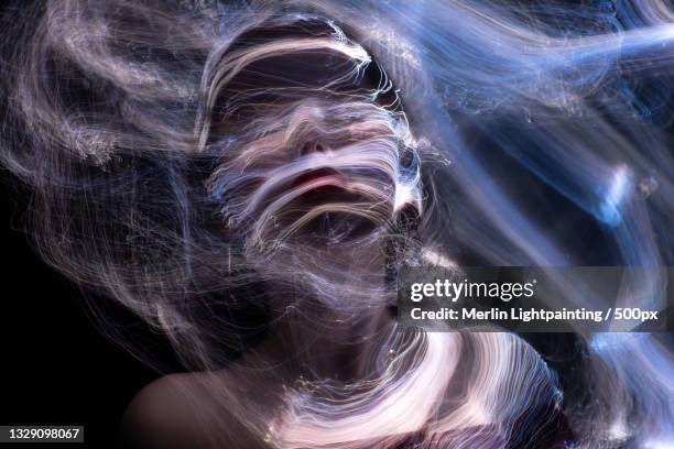 close-up of woman with light painting against black background,russia - digital storytelling stock pictures, royalty-free photos & images