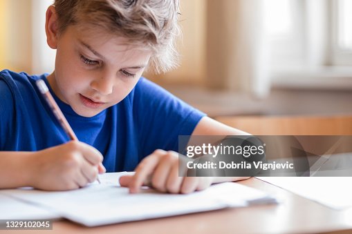 Boy taking notes at class Boy taking notes at class