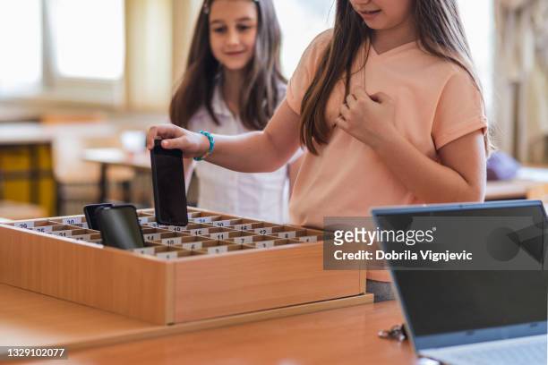 school children placing phones in a box before class - forbidden stock pictures, royalty-free photos & images