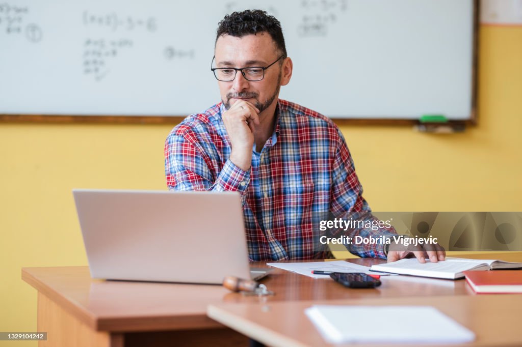 Teacher working on laptop