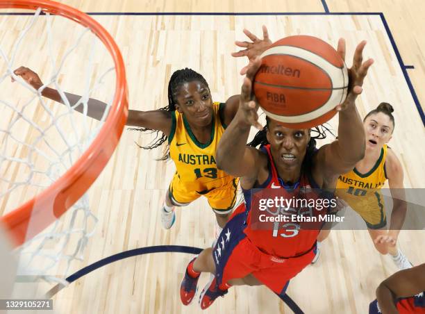 Sylvia Fowles of the United States grabs an offensive rebound against Ezi Magbegor and Katie Ebzery of the Australia Opals during an exhibition game...