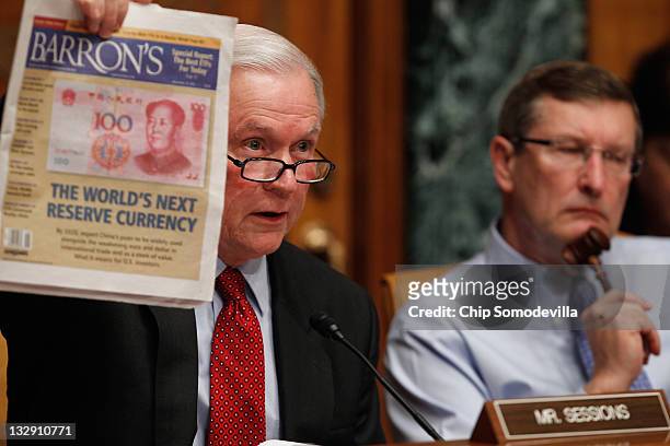 Senate Budget Committee ranking member Sen. Jeff Sessions holds up a copy of Barron's during a hearing with committee Chairman Sen. Kent Conrad on...