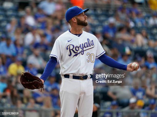 Starting pitcher Danny Duffy of the Kansas City Royals reacts after the stadium lights came on during his windup against the Baltimore Orioles in the...