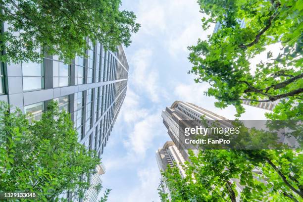 bottom view of modern eco city - skyscraper stock pictures, royalty-free photos & images