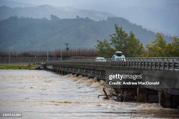 Flood water pushes up against the Motueka River bridge on July 17, 2021 in Nelson, New Zealand. Heavy rain and flooding has led to road closures...