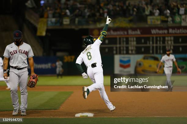 Jed Lowrie of the Oakland Athletics celebrates as he rounds the bases after hitting a two-run walk-off home run in the bottom of the ninth inning to...