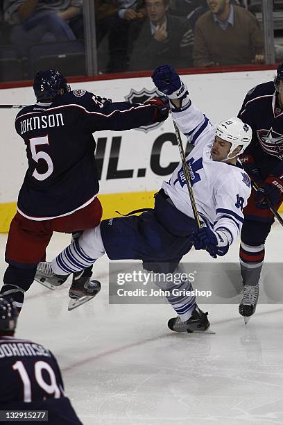 Aaron Johnson of the Columbus Blue Jackets checks Mike Brown of the Toronto Maple Leafs during their game on November 3, 2011 at Nationwide Arena in...