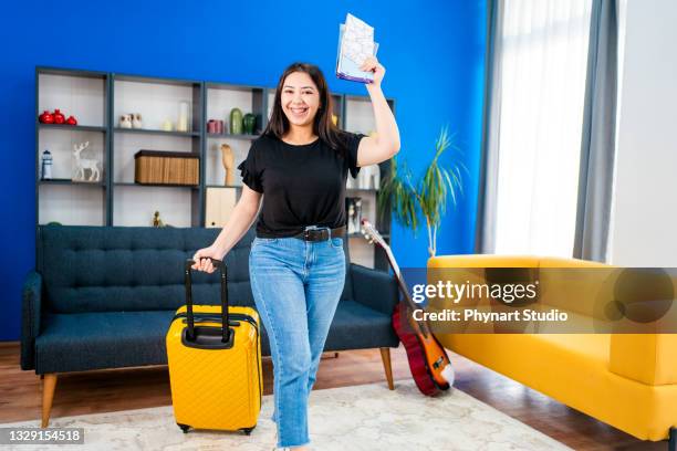 the young girl has completed her holiday preparations and is ready to go. - woman in guitar making studio stock pictures, royalty-free photos & images