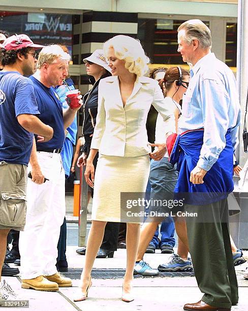 Actress Angelina Jolie stands with her father Jon Voight, right, during a break from filming on the set of the movie "Life or Something Like It" July...