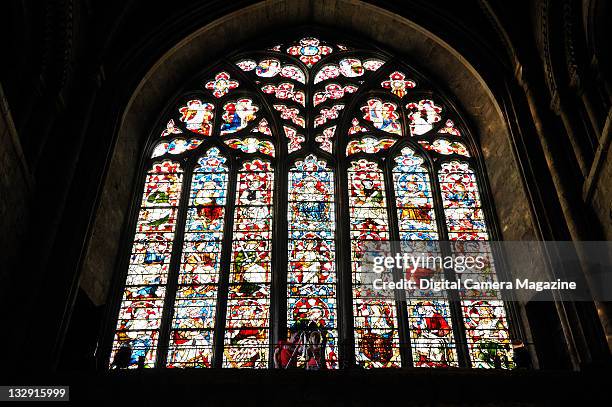 Two photographers take pictures in front of a stained glass window at Durham Cathedral, September 3, 2010.