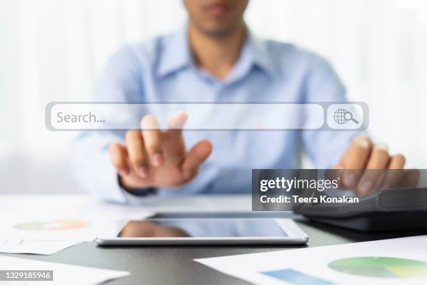job search hiring website, young business man searching for job online a hand holding to touch a phone - searching stock pictures, royalty-free photos & images
