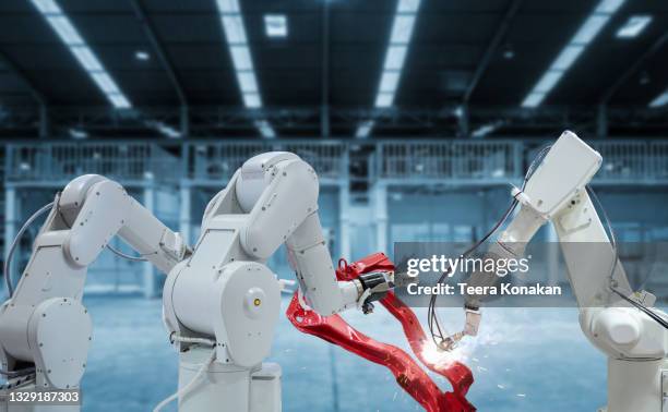 mechanized industry robot arm for assembly in factory production line. - robotic arm factory stock-fotos und bilder