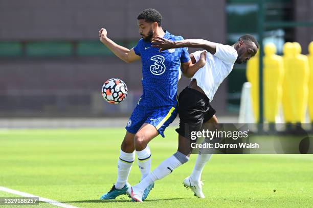 Jake Clarke-Salter of is challenged by battles for possession with Mohamed Eisa of Peterborough United during a Pre-Season Friendly between Chelsea...