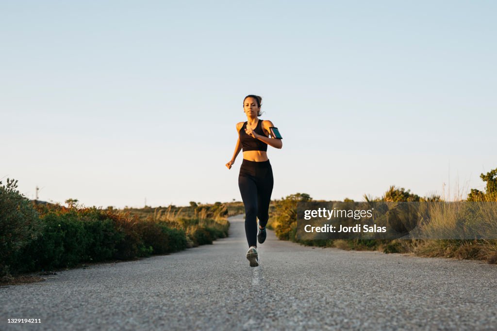 Woman running on a road