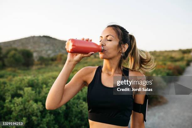 woman drinking water after workout - drink stock pictures, royalty-free photos & images