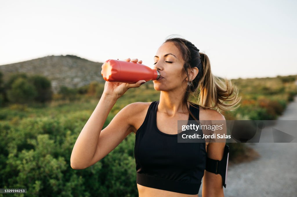 Woman drinking water after workout
