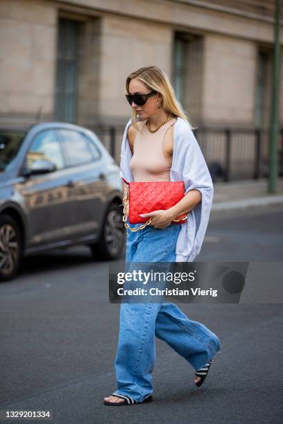 Sonia Lyson is seen wearing Adiletten, denim jeans and sweatshirt Pull & Bear, nude body Zara, red Louis Vuitton bag, Givenchy sunglasses on July 16,...