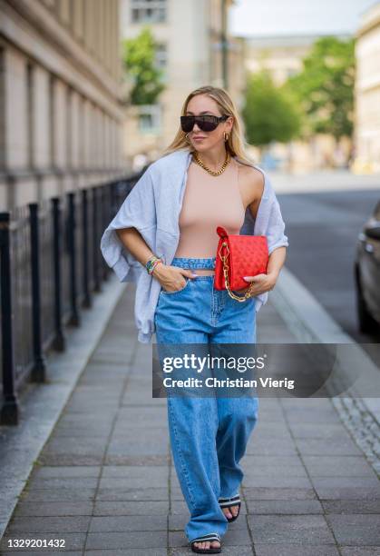 Sonia Lyson is seen wearing Adiletten, denim jeans and sweatshirt Pull & Bear, nude body Zara, red Louis Vuitton bag, Givenchy sunglasses on July 16,...