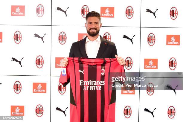 New signing Olivier Giroud of AC Milan poses with the club's shirt at Casa Milan on July 16, 2021 in Milan, Italy.