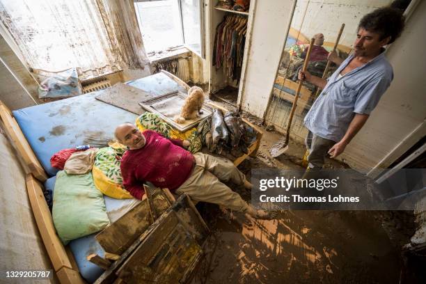 Ulrich Schelleckes and his dog Urmel sit in his bedroom of the apartment, which was completely destroyed by the flood on July 17, 2021 in Bad...