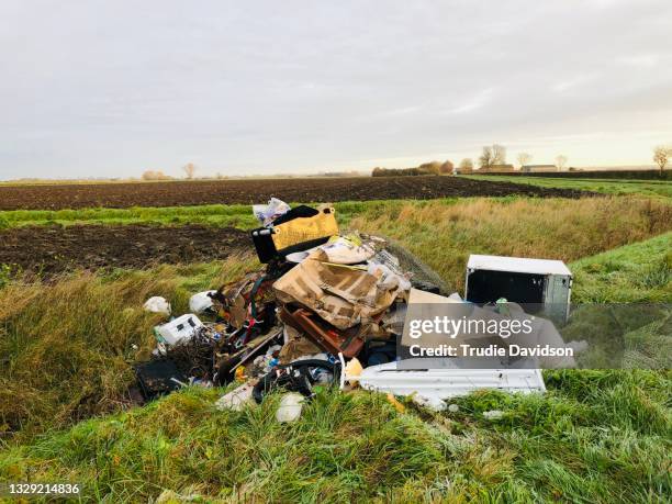 fly-tipped rubbish - crime in the uk stock pictures, royalty-free photos & images