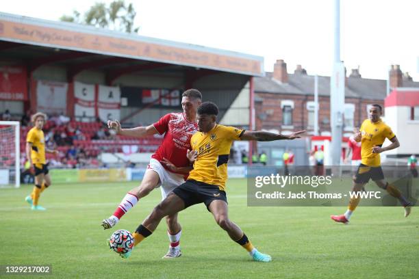 Callum Ainley of Crewe Alexandra battles for possession with Morgan Gibbs-White of Wolverhampton Wanderers during the Pre-Season friendly match...