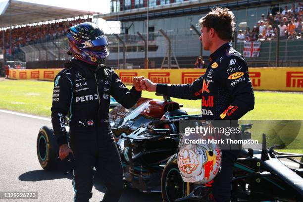 Winner Max Verstappen of Netherlands and Red Bull Racing and second placed Lewis Hamilton of Great Britain and Mercedes GP bump fists in parc ferme...