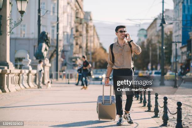 man traveling solo around the world - tourist talking on the phone stock pictures, royalty-free photos & images
