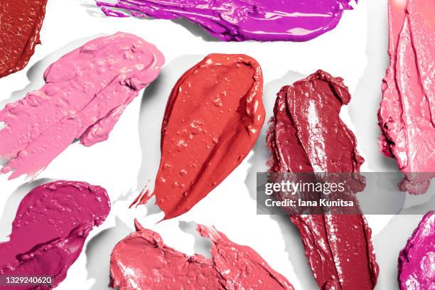 red, pink, purple, burgundy lipstick smears on white background. isolated for design. lip gloss samples are smudged. beauty cosmetic banner. makeup and skin care products. closeup. - pink lipstick smear stock pictures, royalty-free photos & images